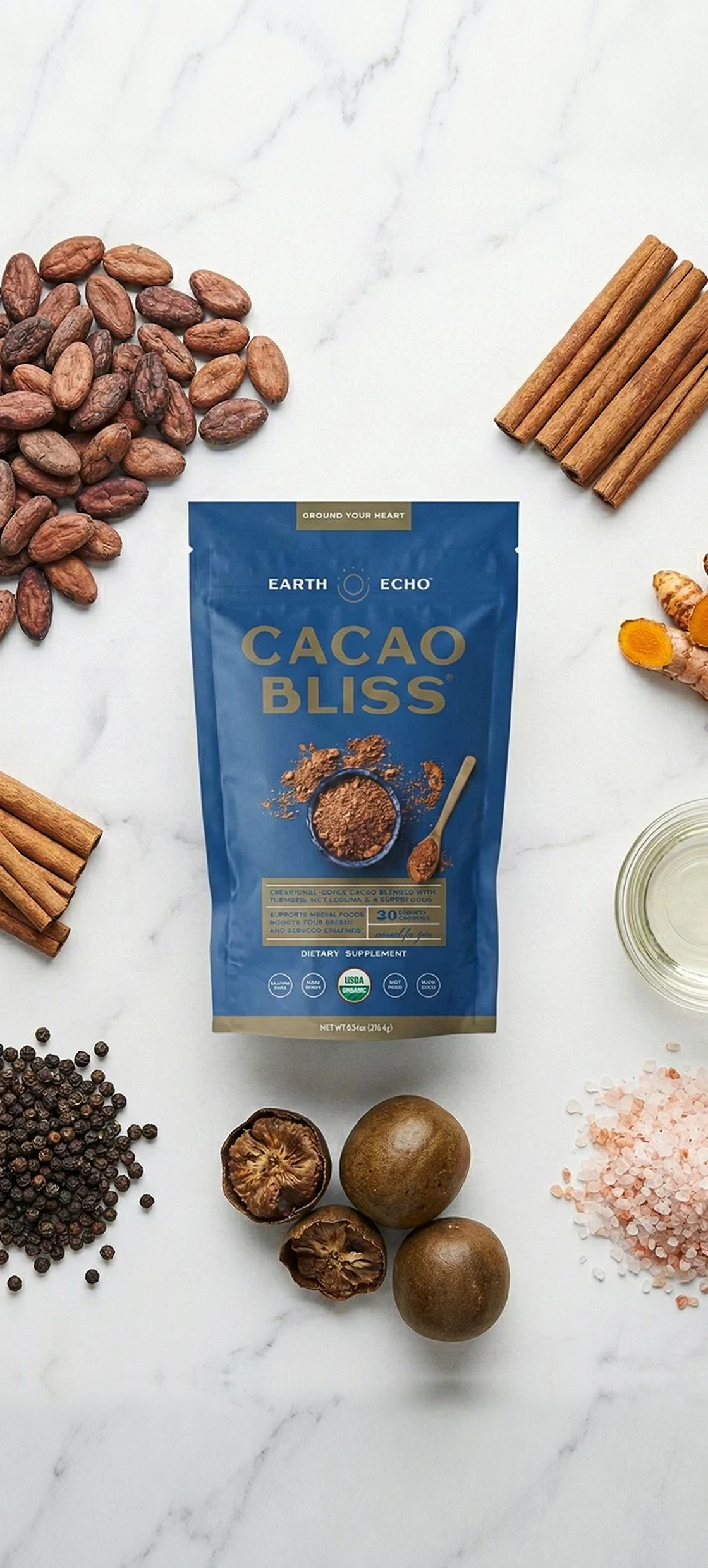 Cacao Bliss pouch surrounded by cacao beans, cinnamon sticks, turmeric root, black peppercorns, monk fruit, MCT oil and Himalayan salt